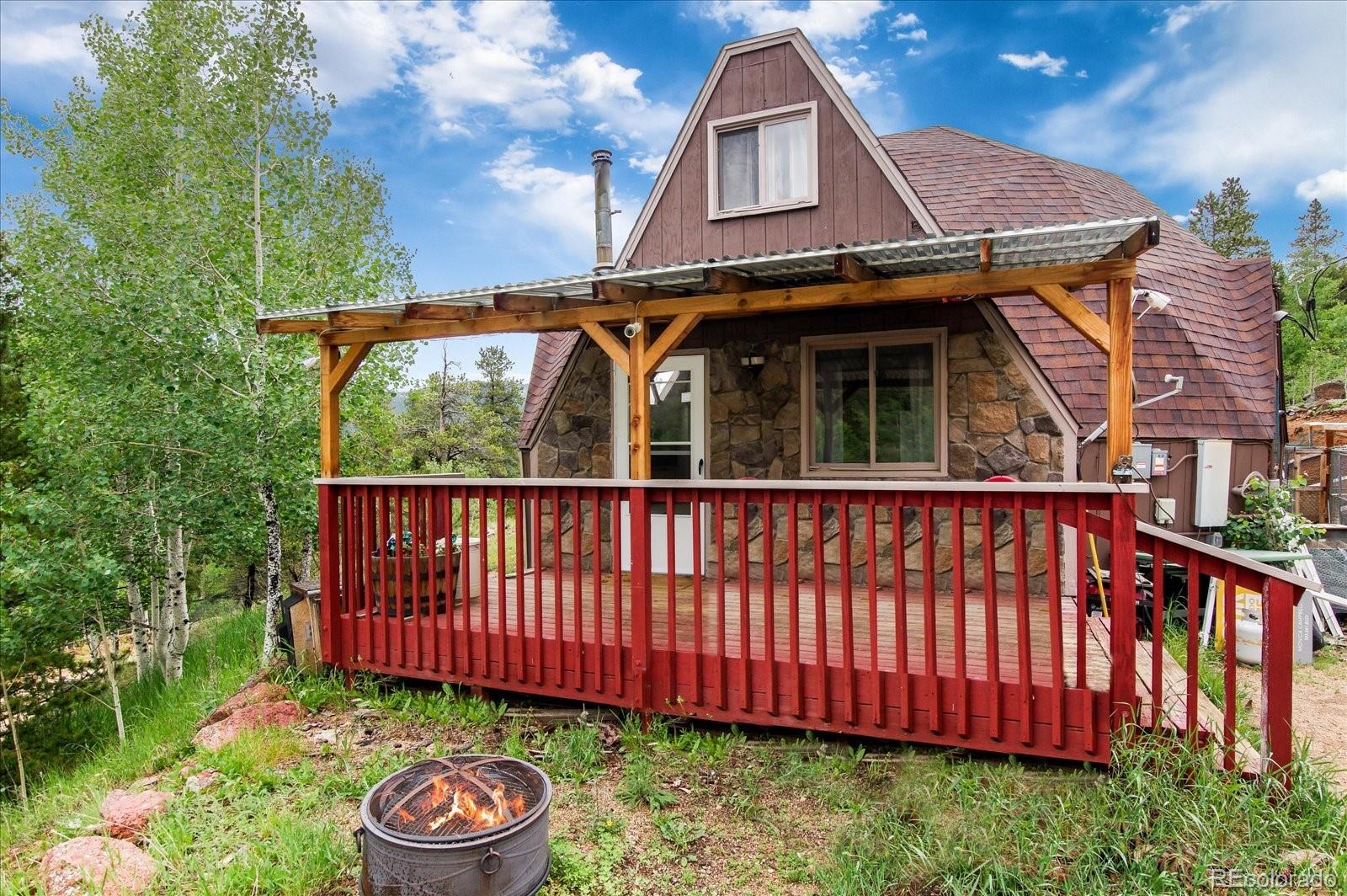 136 Lakeview Road Bailey, CO 80421 - Photo 1 of 40 a view of a small yard with furniture
