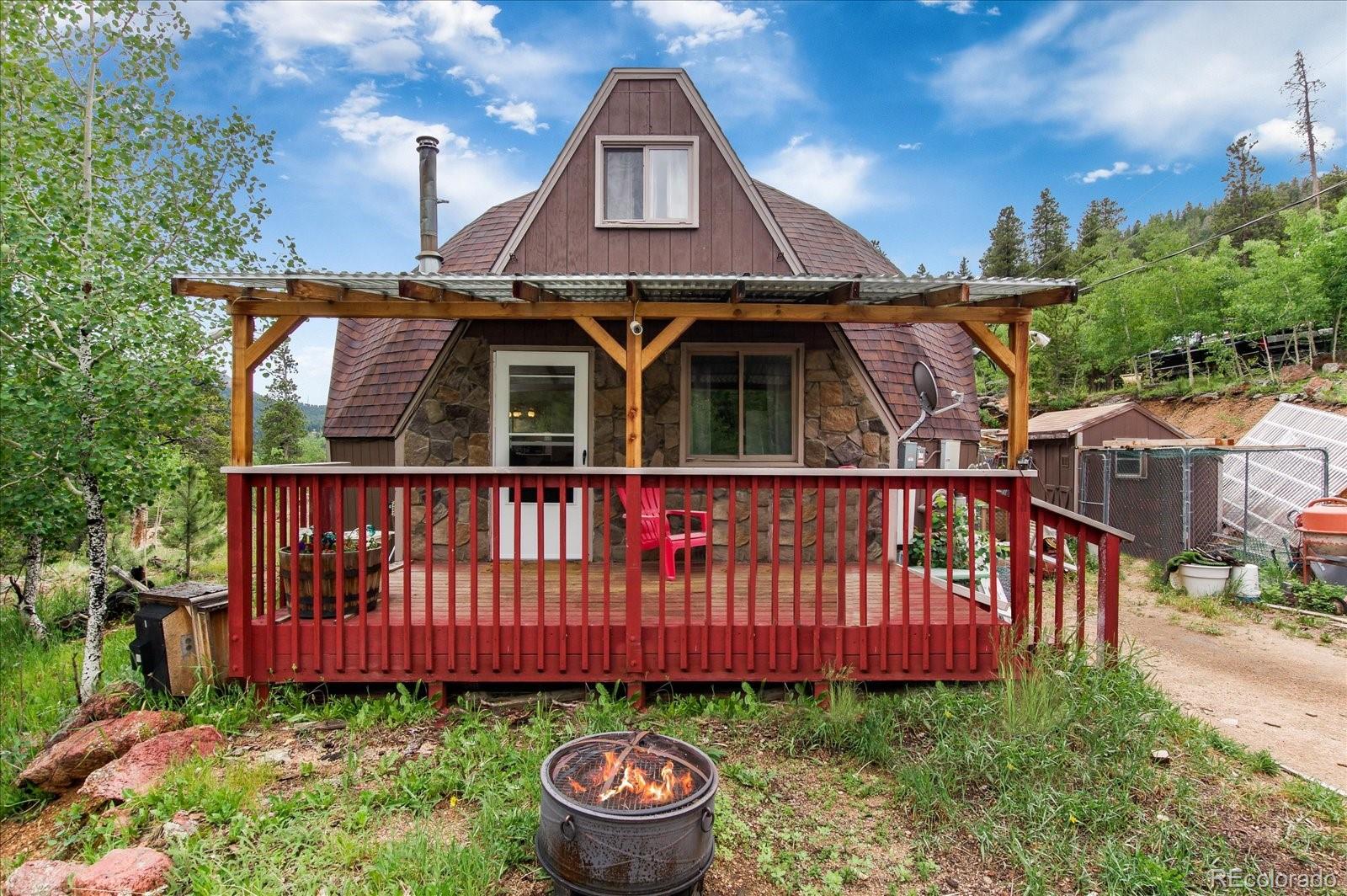 136 Lakeview Road Bailey, CO 80421 - Photo 8 of 40 a front view of a house with yard and furniture