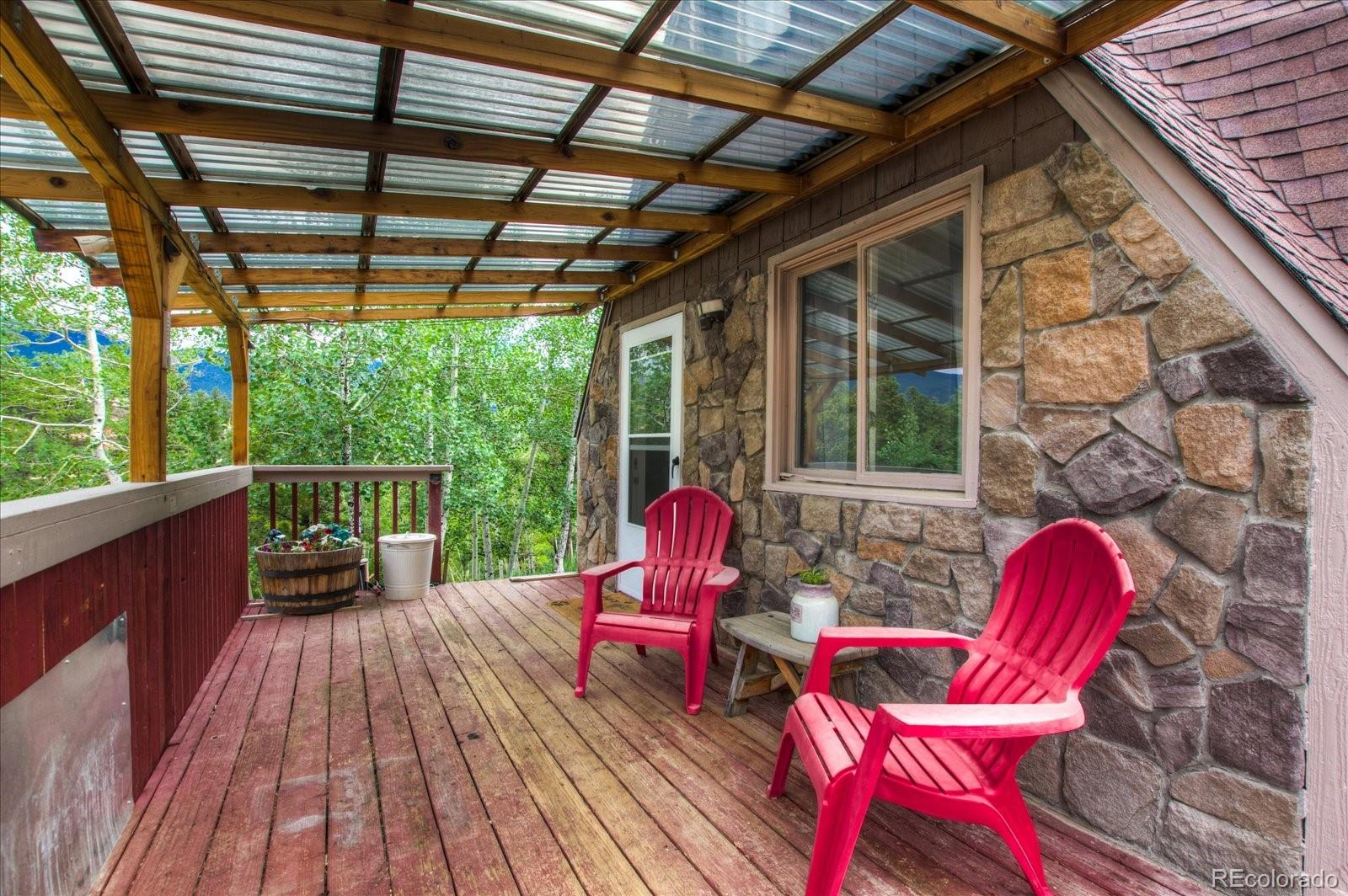 136 Lakeview Road Bailey, CO 80421 - Photo 10 of 40 a patio with lawn chairs and wooden floor