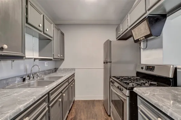 a kitchen with stainless steel appliances granite countertop a sink stove and refrigerator