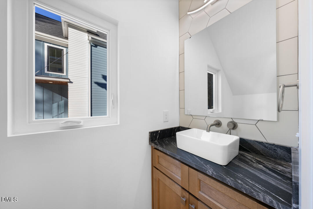 2530 West Wilson Street Durham, NC 27705 - Photo 24 of 49 a bathroom with a sink and a mirror