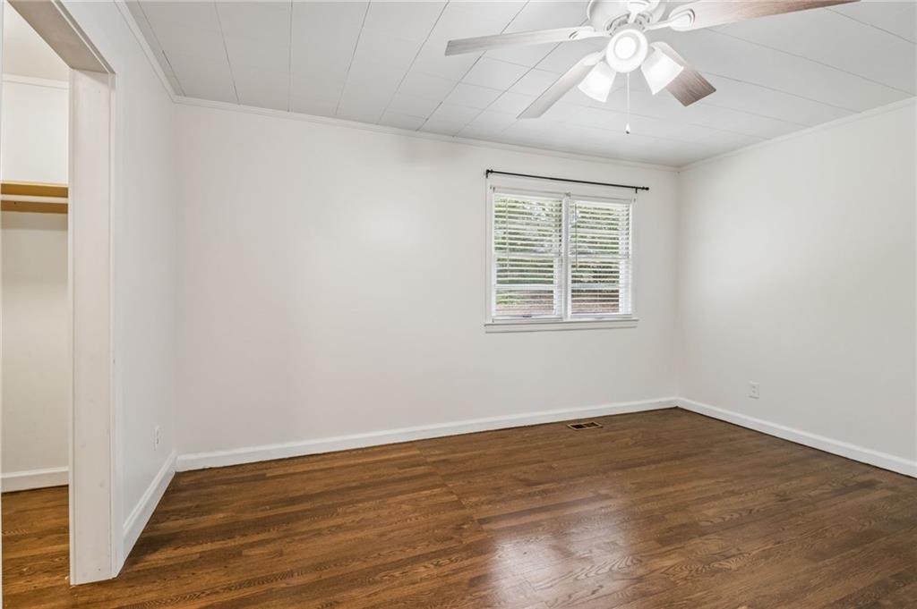 358 Peevy Street Buford, GA 30518 - Photo 11 of 18 a view of an empty room with wooden floor and a window