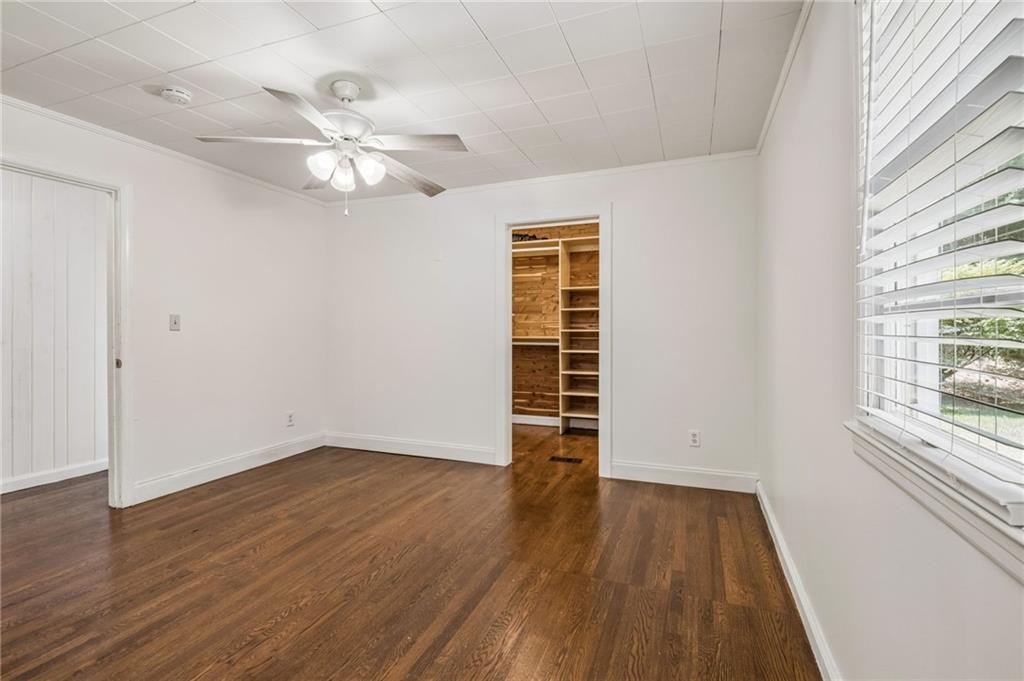 358 Peevy Street Buford, GA 30518 - Photo 12 of 18 wooden floor in an empty room with a window