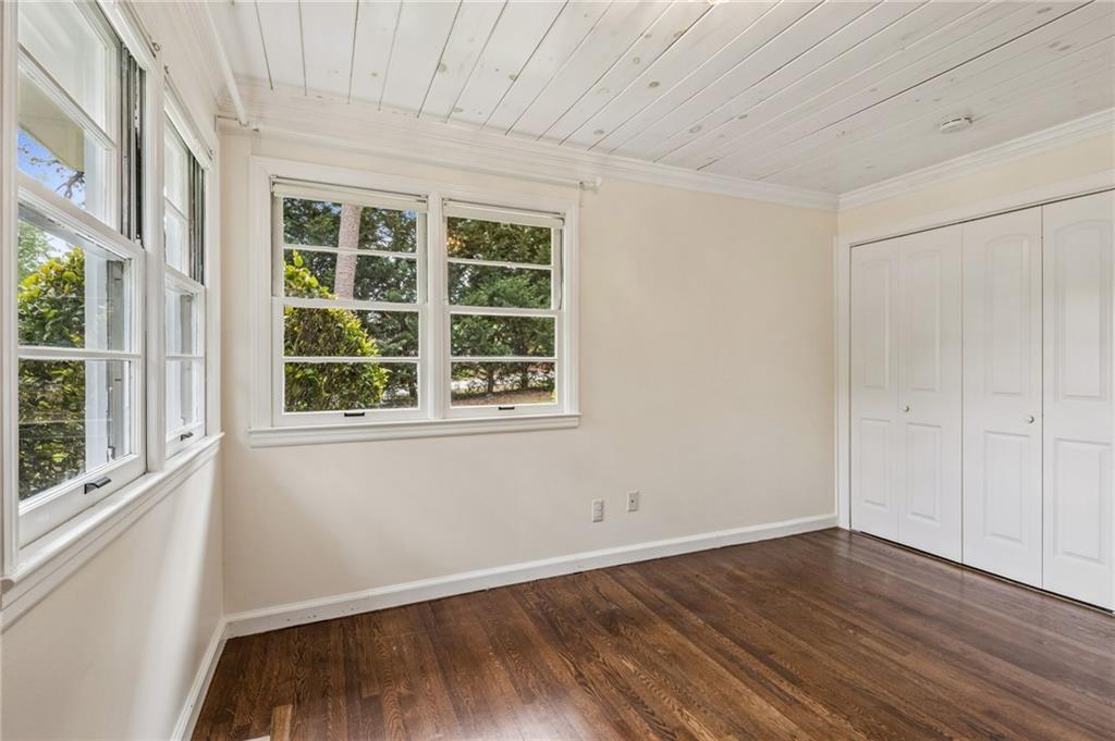 358 Peevy Street Buford, GA 30518 - Photo 14 of 18 an empty room with wooden floor and windows
