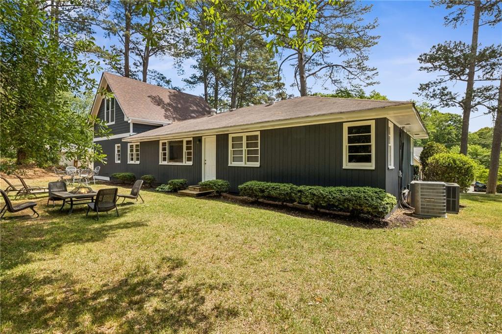 358 Peevy Street Buford, GA 30518 - Photo 18 of 18 a view of a house with patio and a yard