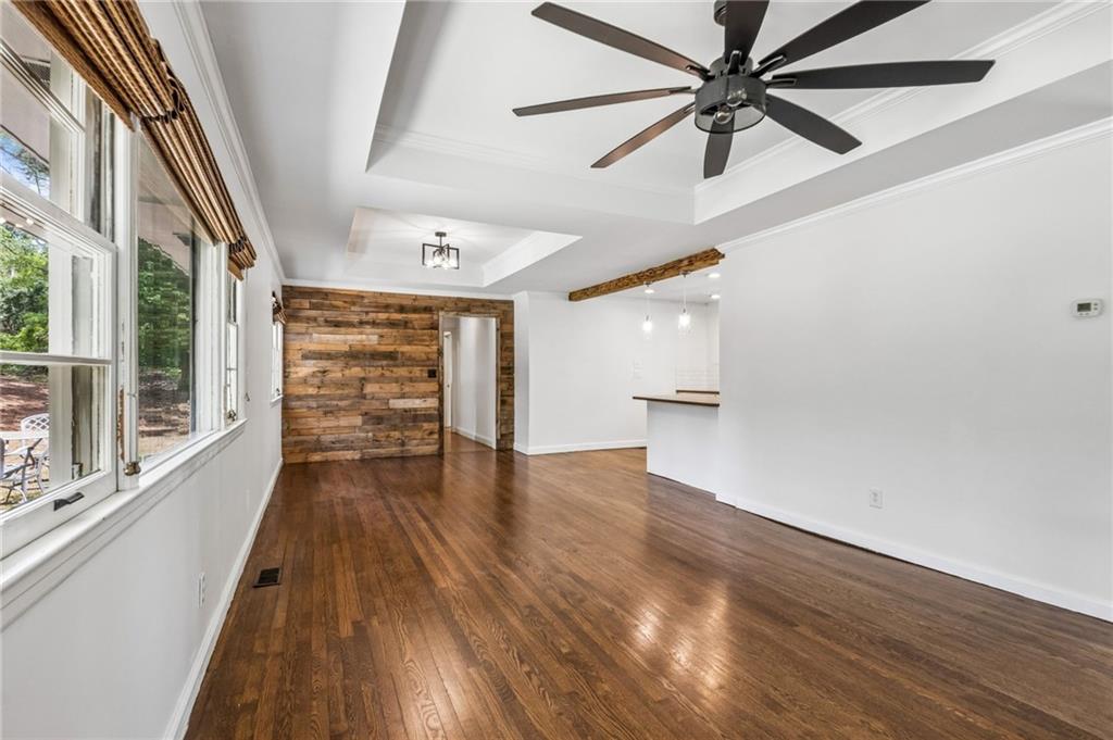 358 Peevy Street Buford, GA 30518 - Photo 3 of 18 wooden floor in an empty room with a window