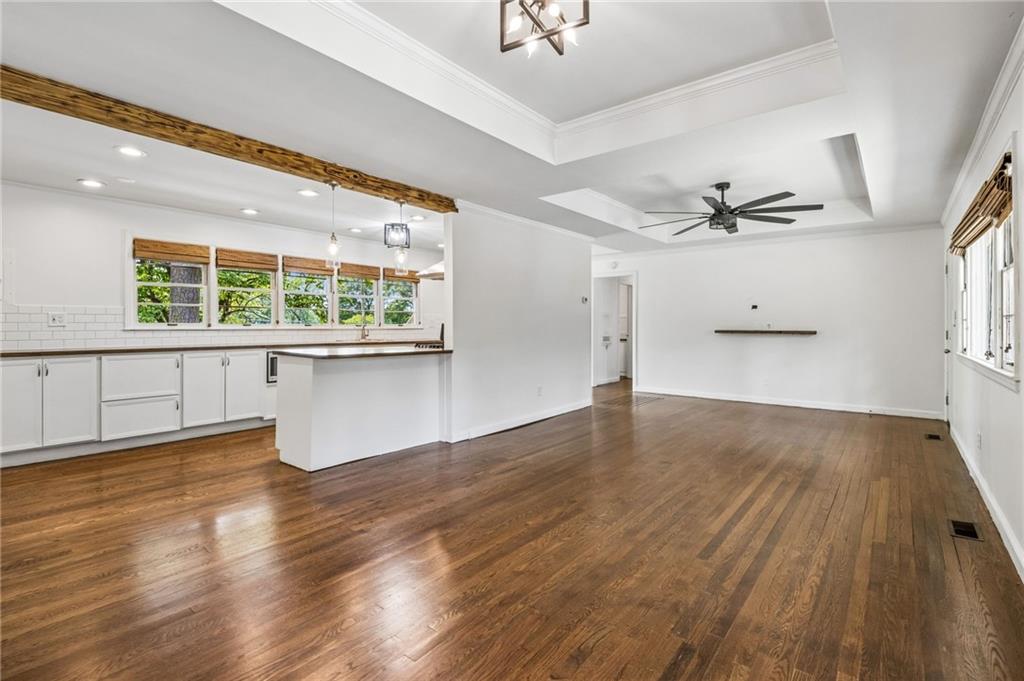 358 Peevy Street Buford, GA 30518 - Photo 4 of 18 wooden floor in an empty room with a window