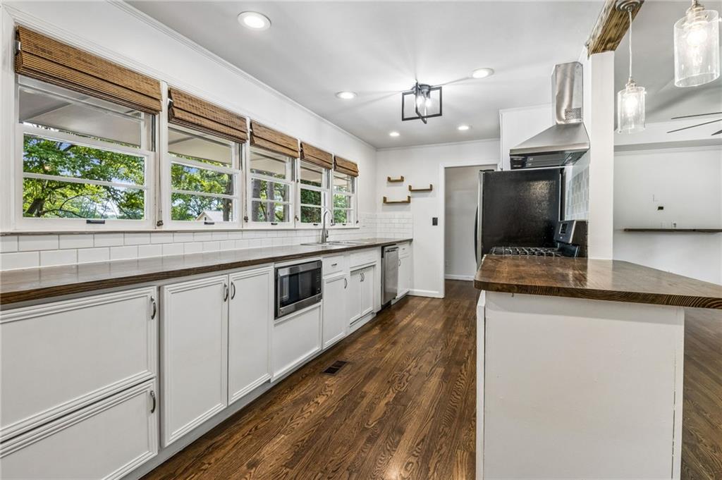 358 Peevy Street Buford, GA 30518 - Photo 5 of 18 a large kitchen with granite countertop a stove and a sink