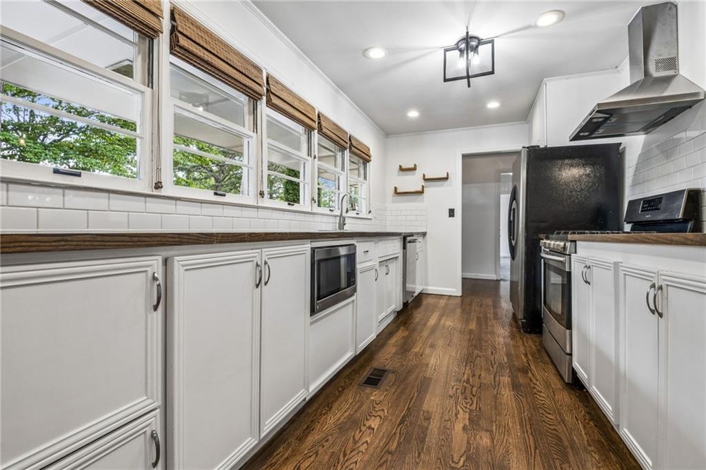 358 Peevy Street Buford, GA 30518 - Photo 8 of 18 a kitchen with stainless steel appliances a stove top oven a sink and a refrigerator