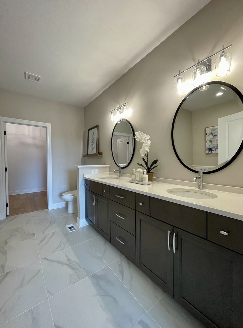 15960 Prairie View, Unit T10 Lockport, IL 60441 - Photo 26 of 29 a bathroom with a double vanity sink and a mirror