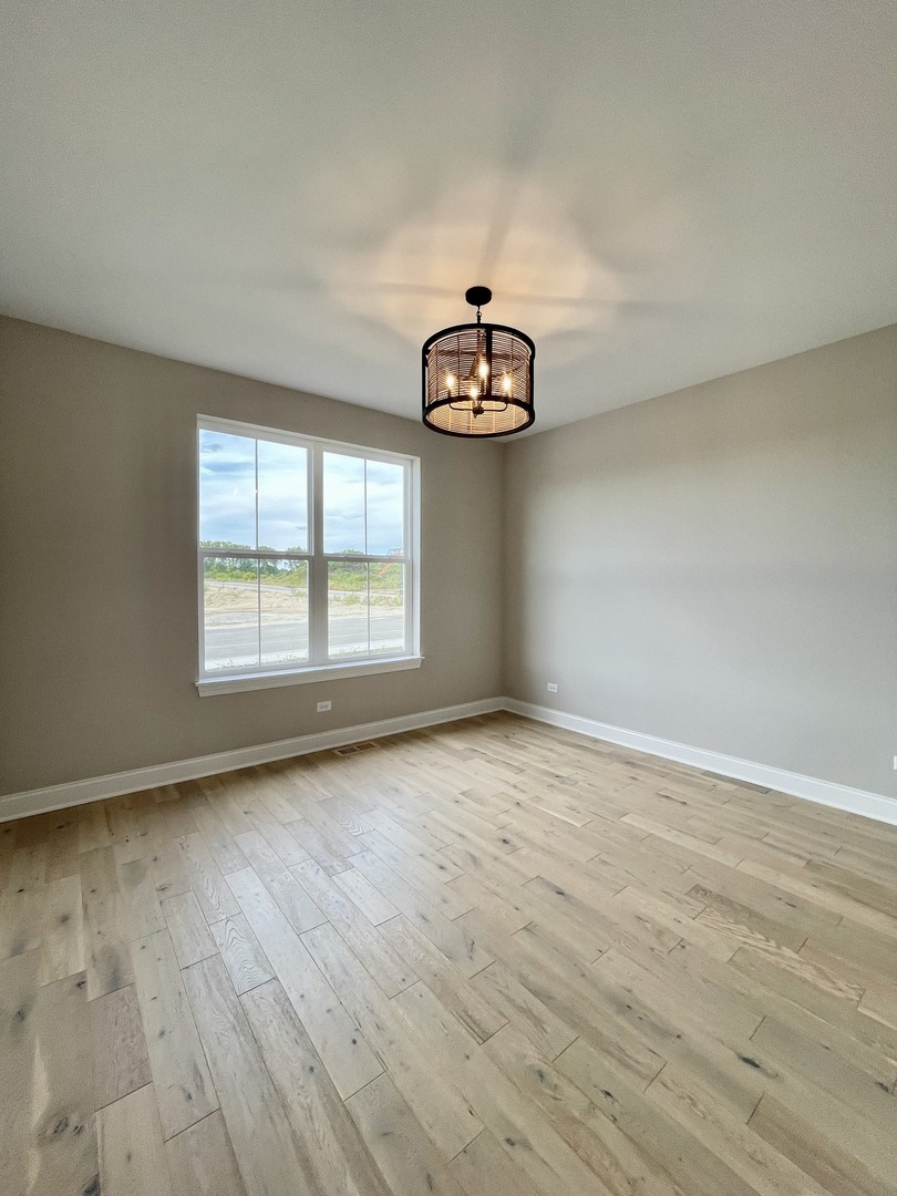 15960 Prairie View, Unit T10 Lockport, IL 60441 - Photo 28 of 29 an empty room with wooden floor and windows