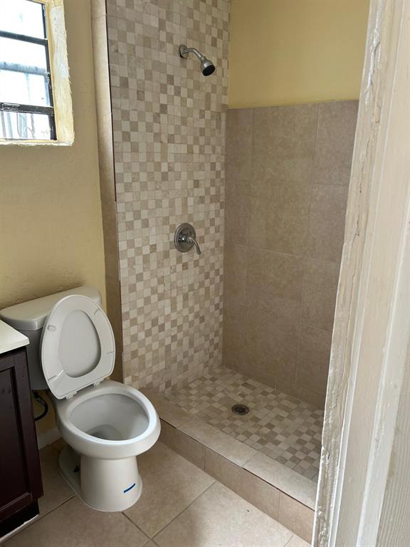 371 Banyan Avenue Pahokee, FL 33476 - Photo 3 of 12 a white toilet sitting next to a shower