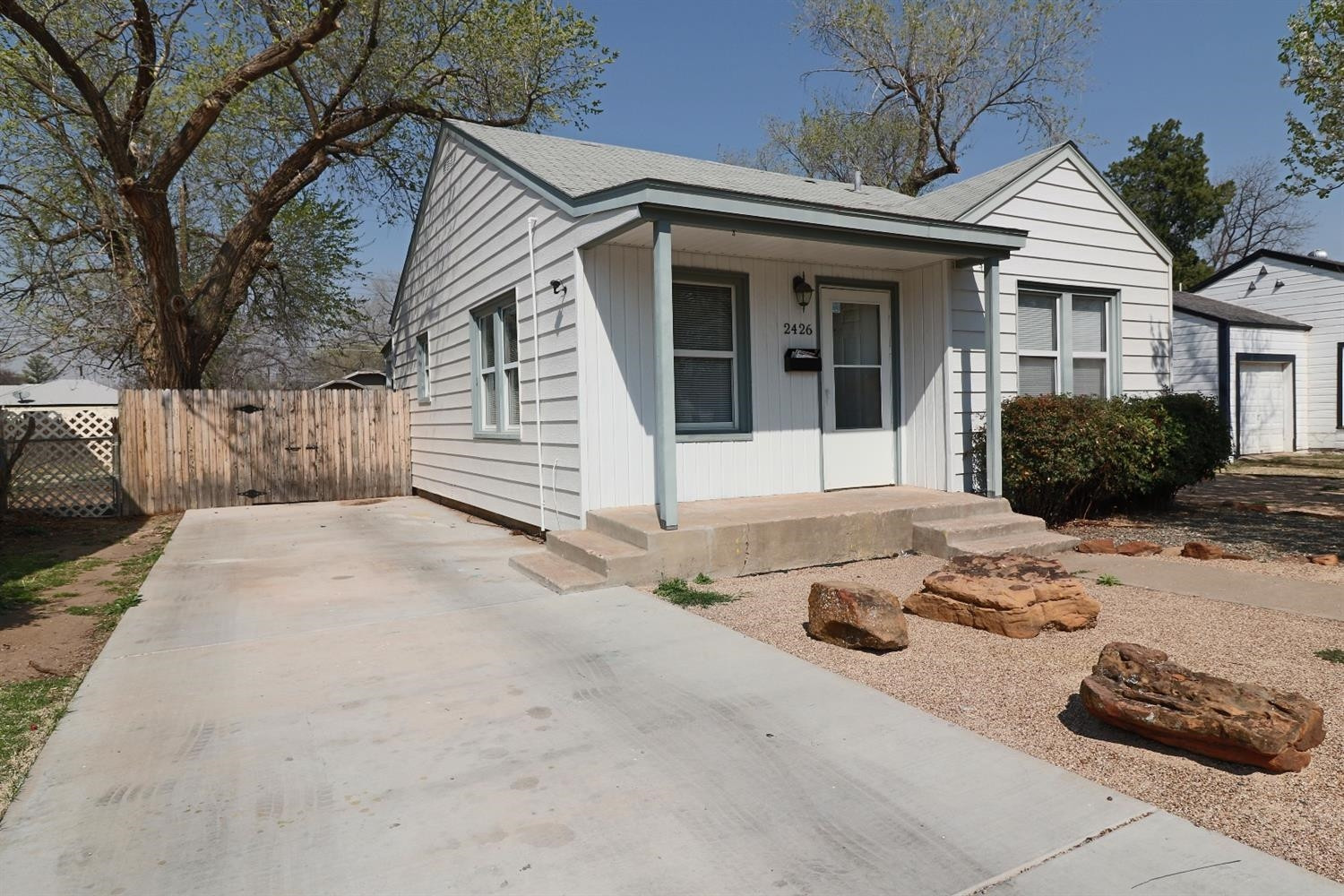 2426 26th Street Lubbock, TX 79411 - Photo 3 of 10 a front view of a house with a yard