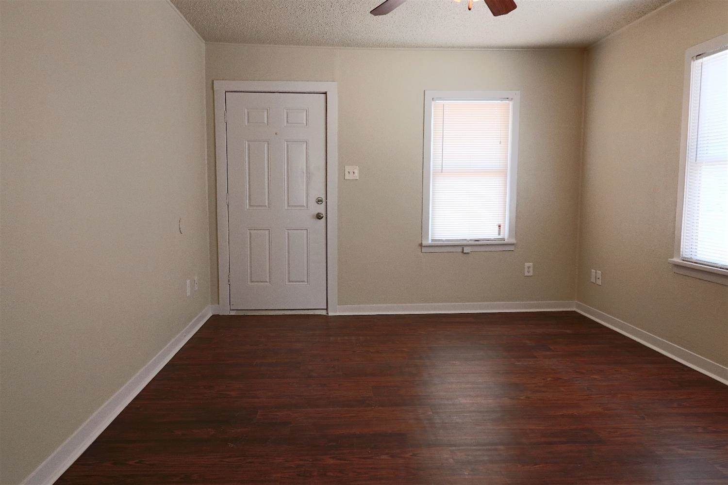 2426 26th Street Lubbock, TX 79411 - Photo 5 of 10 an empty room with wooden floor and windows