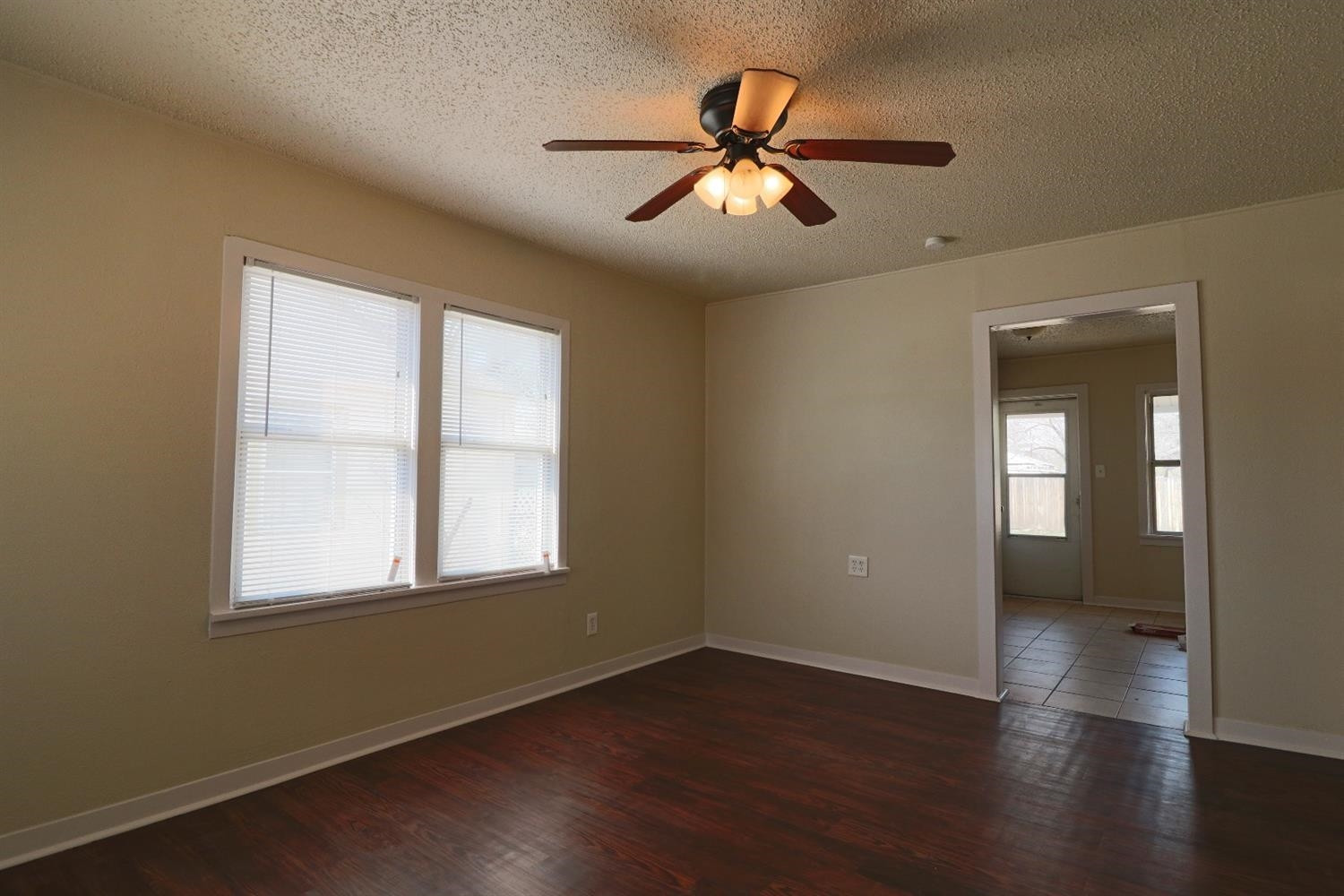2426 26th Street Lubbock, TX 79411 - Photo 6 of 10 a view of an empty room with wooden floor and a window