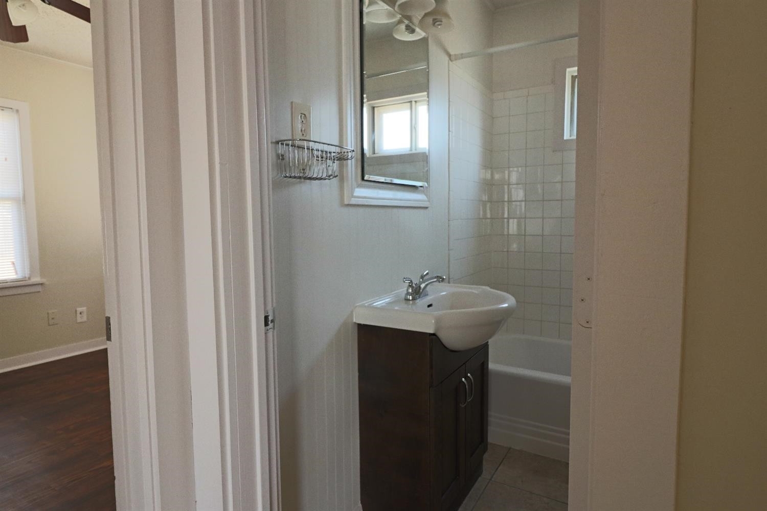 2426 26th Street Lubbock, TX 79411 - Photo 9 of 10 a bathroom with a sink a mirror and a toilet