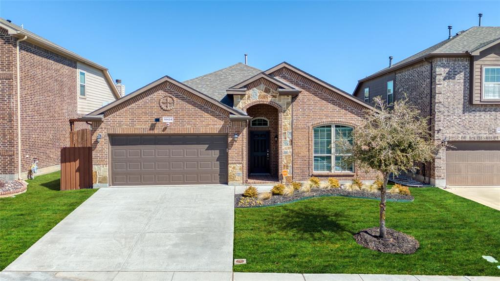 10424 Misty Redwood Trail Fort Worth, TX 76177 - Photo 1 of 27 a front view of a house with a yard and garage