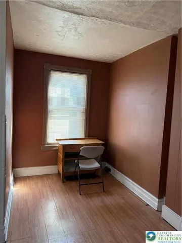 a room with wooden floor and furniture