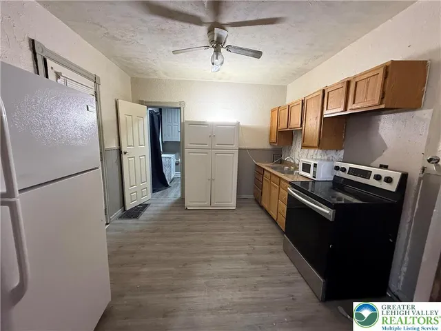 a kitchen with stainless steel appliances a refrigerator and a stove