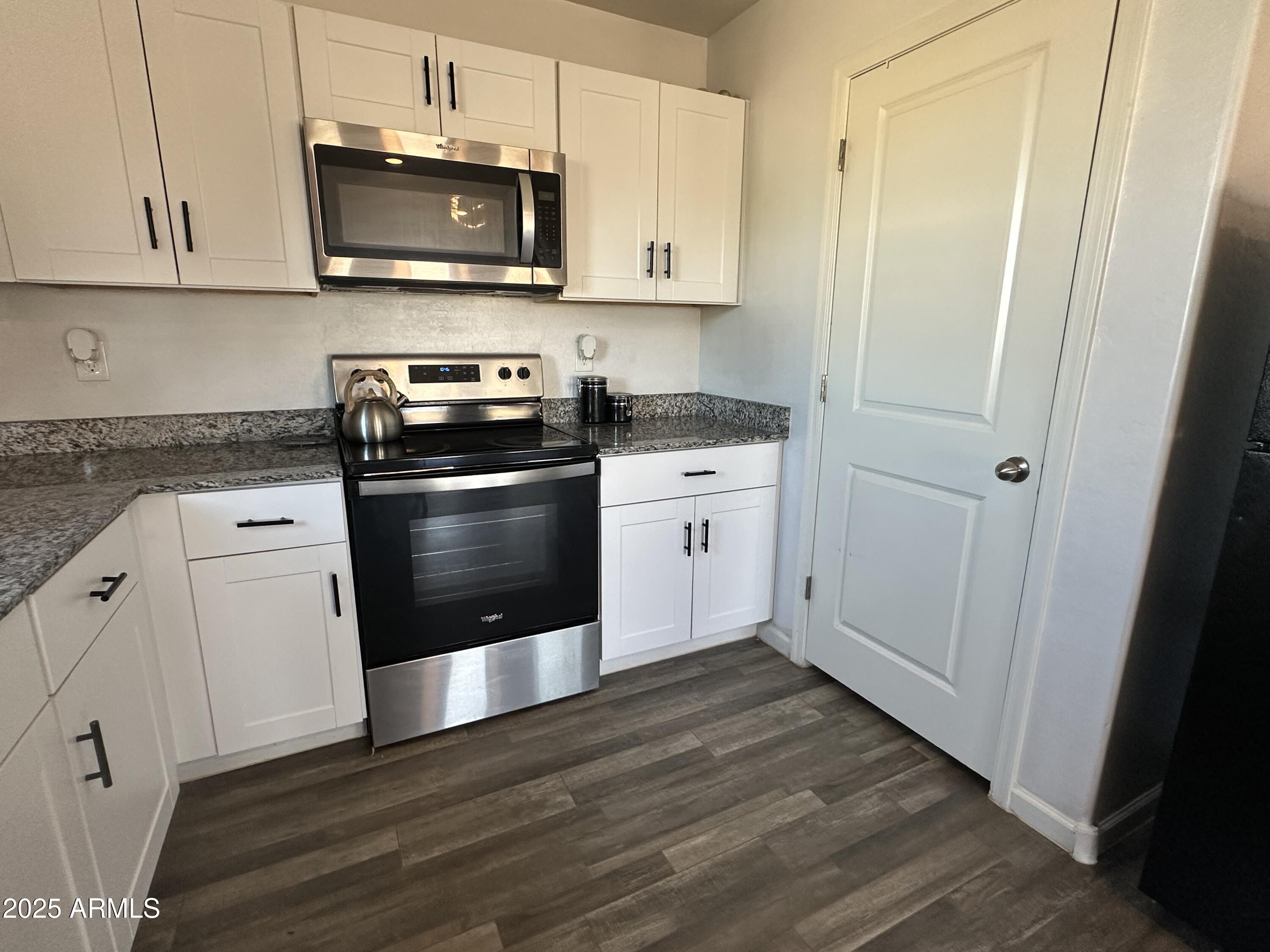 14852 South Diablo Road Arizona City, AZ 85123 - Photo 26 of 30 a kitchen with stainless steel appliances granite countertop a stove a sink and a refrigerator