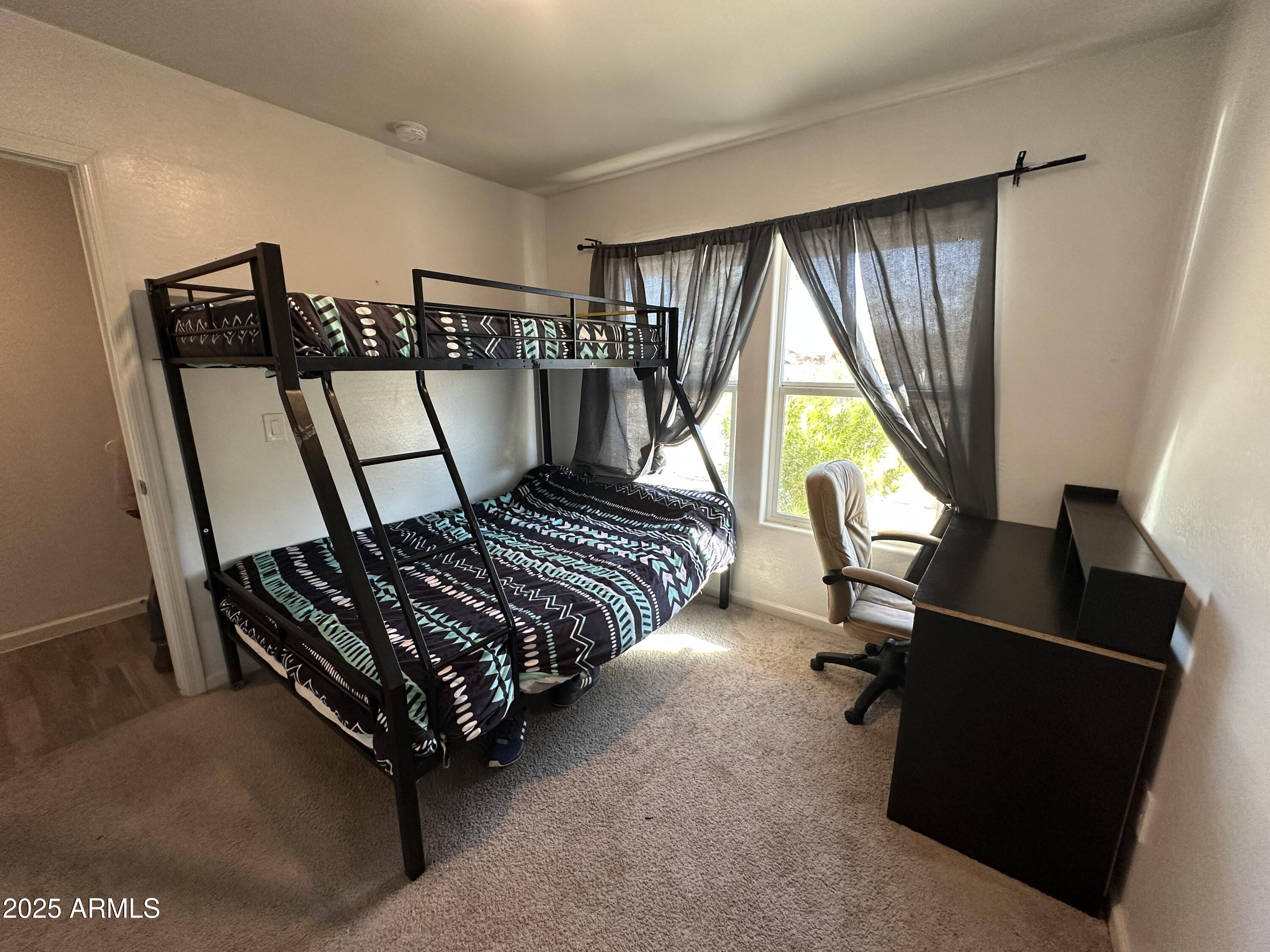 14852 South Diablo Road Arizona City, AZ 85123 - Photo 7 of 30 a bedroom with bed and a window