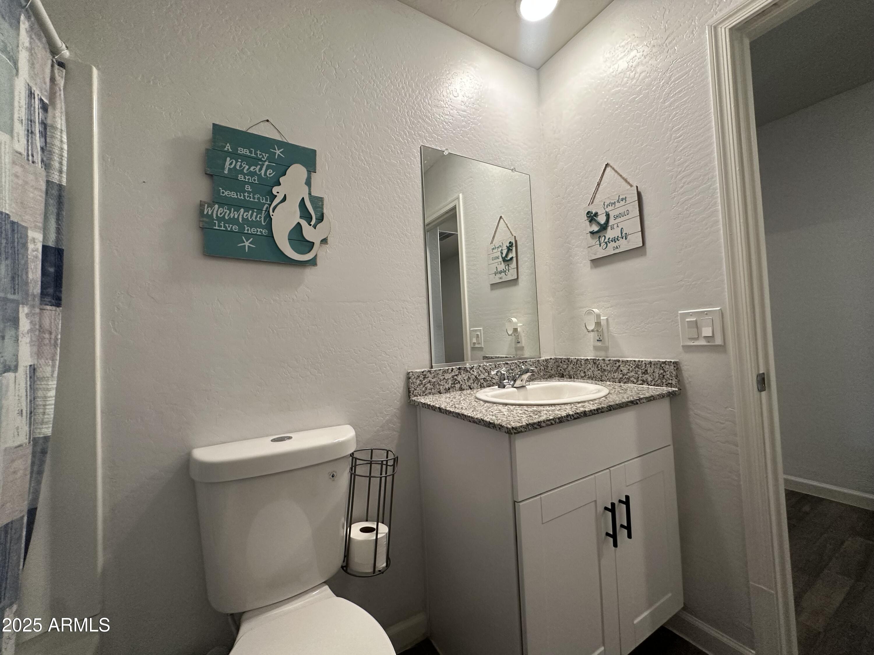 14852 South Diablo Road Arizona City, AZ 85123 - Photo 10 of 30 a bathroom with a granite countertop toilet sink and mirror