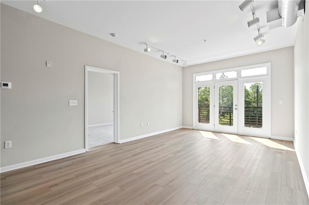 5300 Peachtree Road, Unit 3308 Atlanta, GA 30341 - Photo 11 of 45 a view of an empty room with wooden floor and a window