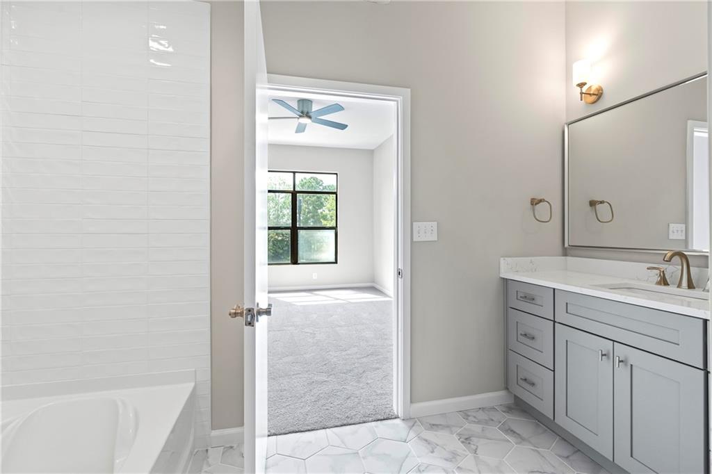 5300 Peachtree Road, Unit 3308 Atlanta, GA 30341 - Photo 17 of 45 a bathroom with a shower sink and mirror