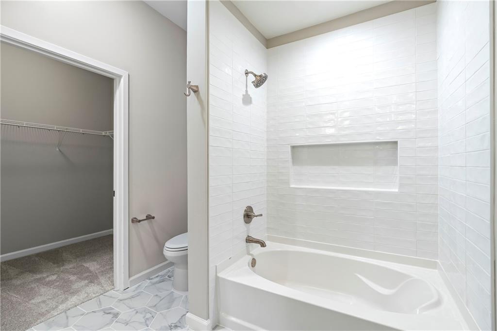 5300 Peachtree Road, Unit 3308 Atlanta, GA 30341 - Photo 18 of 45 a bathroom with a bathtub and a shower