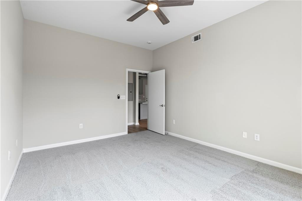 5300 Peachtree Road, Unit 3308 Atlanta, GA 30341 - Photo 25 of 45 an empty room with a ceiling fan and carpet