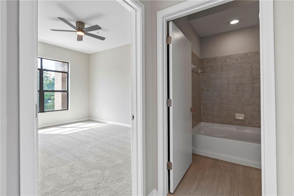 5300 Peachtree Road, Unit 3308 Atlanta, GA 30341 - Photo 26 of 45 a view of an empty room and a bathroom with a bathtub