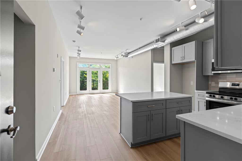 5300 Peachtree Road, Unit 3308 Atlanta, GA 30341 - Photo 3 of 45 a kitchen with a stove a sink and cabinets