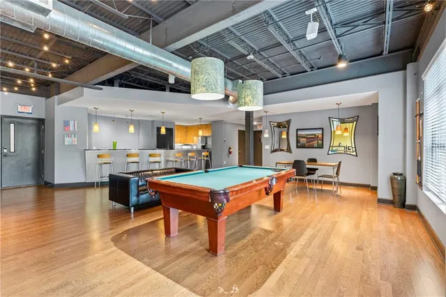 a dining room with furniture and a flat screen tv