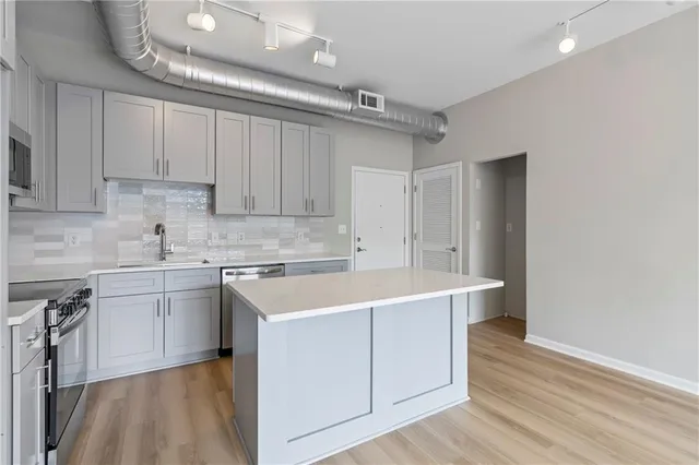 a kitchen with a sink stove and cabinets