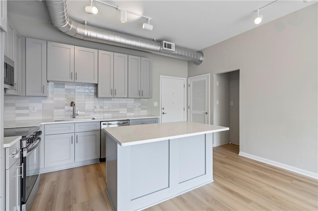 5300 Peachtree Road, Unit 3308 Atlanta, GA 30341 - Photo 5 of 45 a kitchen with a sink stove and cabinets