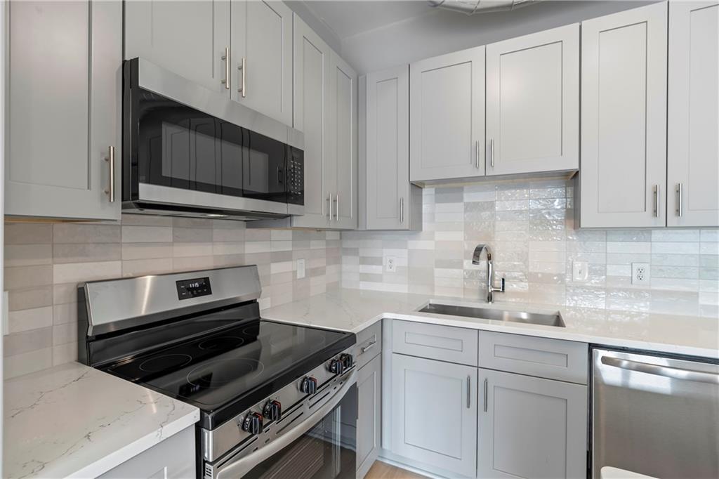 5300 Peachtree Road, Unit 3308 Atlanta, GA 30341 - Photo 7 of 45 a kitchen with appliances a sink and cabinets
