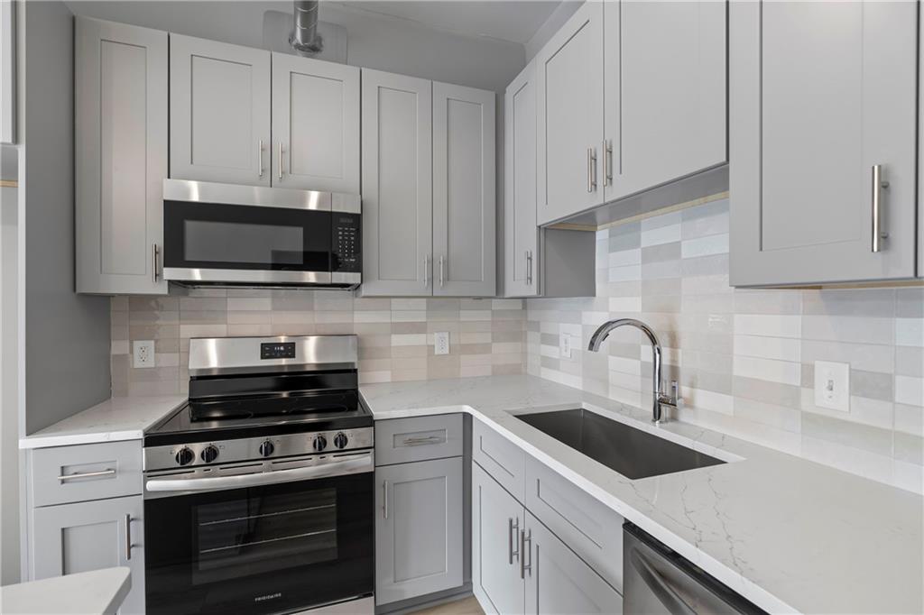 5300 Peachtree Road, Unit 3308 Atlanta, GA 30341 - Photo 8 of 45 a kitchen with cabinets appliances a sink and a counter top