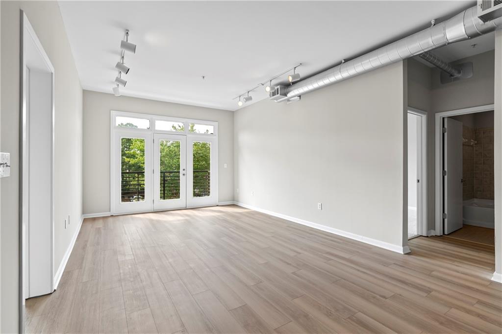 5300 Peachtree Road, Unit 3308 Atlanta, GA 30341 - Photo 10 of 45 a view of an empty room with wooden floor and a window