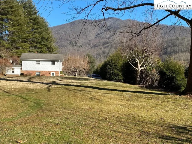 en empty room with windows and chandelier fan