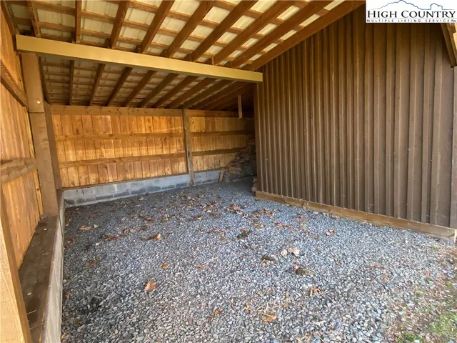 a view of a dry yard with mountains in the background