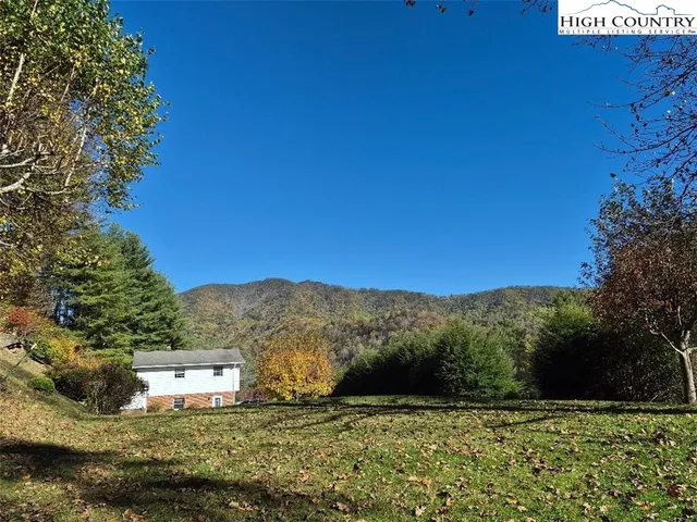 a backyard of a house with large trees