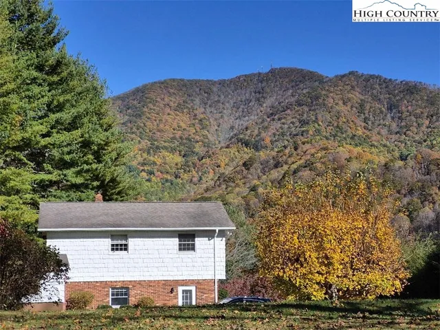 a view of a brick house with a yard