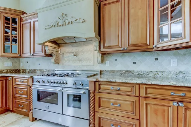 a kitchen that has a oven a sink and cabinets