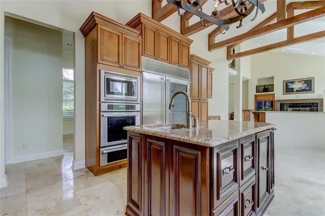 a kitchen with stainless steel appliances granite countertop a stove and a microwave
