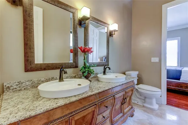 a bedroom with a bed and a ceiling fan