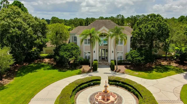 a bedroom with a bed chandelier and a window