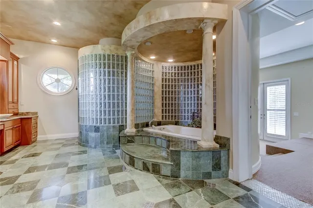 a bathroom with a tub sink and mirror