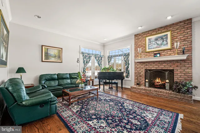 a living room with furniture a rug and a fireplace