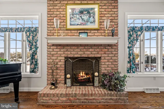 a living room with a fireplace and a floor to ceiling window