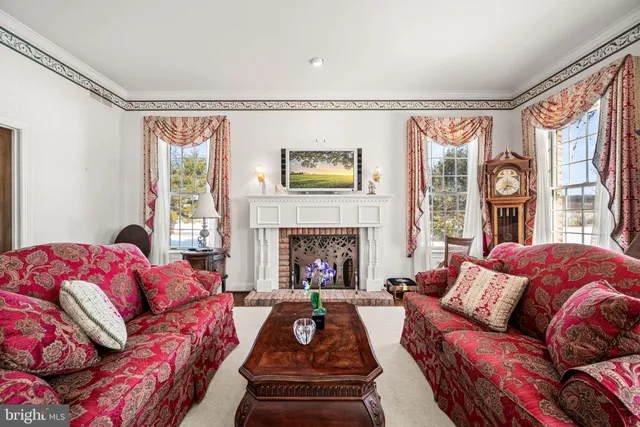 a living room with furniture fireplace and a large window